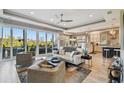 Bright living room with modern decor, opening to a deck with scenic views; features updated kitchen at 1720 Mariner Way, Tarpon Springs, FL 34689