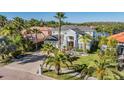 A lovely two-story home with a gray exterior, lush landscaping, and a paved driveway at 17927 Bahama Isle Cir, Tampa, FL 33647