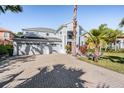 Charming two-story home with a three-car garage and a brick-paved driveway at 17927 Bahama Isle Cir, Tampa, FL 33647