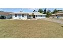 A bright, single-story home with a well-maintained lawn and mature landscaping at 1929 New Bedford Dr, Sun City Center, FL 33573