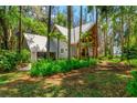 Home featuring a metal roof, a circular window, and a matching detached garage at 20926 Ragan Ln, Land O Lakes, FL 34638