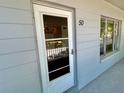 Close up of condo entrance door with glass and address number at 2100 World Parkway Blvd # 50, Clearwater, FL 33763