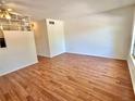 Living room with wood floors and white walls, with a ceiling fan and a decorative partition at 2100 World Parkway Blvd # 50, Clearwater, FL 33763