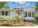 Charming two-story home with a beautifully landscaped front yard and a light blue exterior at 2217 Brevard Ne Rd, St Petersburg, FL 33704