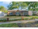 Charming single-story home with blue shutters and a manicured front lawn at 2931 W Coachman Ave, Tampa, FL 33611