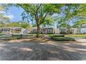 Inviting single-story home on a tree-lined street with charming brick accents at 2931 W Coachman Ave, Tampa, FL 33611