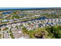 Aerial view of a waterfront community with homes along canals, offering scenic living at 5236 Wishing Arch Dr, Apollo Beach, FL 33572