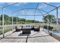 Covered patio with comfortable seating, perfect for relaxing and enjoying the outdoor view at 5236 Wishing Arch Dr, Apollo Beach, FL 33572