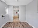 Bright, airy room with wood flooring and a view of the kitchen area at 5340 4Th S Ave, St Petersburg, FL 33707