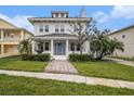 Charming two-story home features a welcoming front yard with a fountain and beautiful landscaping at 5426 Venetian Ne Blvd, St Petersburg, FL 33703