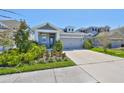 Attractive home with a manicured lawn, vibrant flowerbeds, and a spacious driveway leading to the garage at 5523 Del Coronado Dr, Apollo Beach, FL 33572
