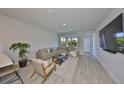 Stylish living room with modern furniture, hardwood floors, and large windows, creating an inviting atmosphere at 5523 Del Coronado Dr, Apollo Beach, FL 33572