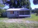 Exterior view of a single-story home with siding, porch, and metal roof at 710 E 129Th Ave, Tampa, FL 33612