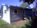 Back view of a home with siding and greenery at 710 E 129Th Ave, Tampa, FL 33612