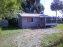 A single-story home with siding, front porch and metal roof on a sunny day at 710 E 129Th Ave, Tampa, FL 33612