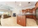 Open-concept kitchen featuring granite countertops, custom cabinets, and views of the living area at 819 Birdie Way, Apollo Beach, FL 33572