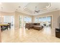 Bright and airy living room with tile floors and sliding glass doors leading to the pool at 819 Birdie Way, Apollo Beach, FL 33572