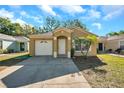 Attractive single-story home with a one-car garage, an arched doorway, and a concrete driveway at 8528 Quarter Horse Dr, Riverview, FL 33578