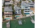 Beautiful elevated waterfront homes featuring a private pools, docks, and boat lifts with coastal charm at 8685 E Bay Dr, Treasure Island, FL 33706