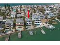 Beautiful elevated waterfront home featuring a private pool, dock, and boat lift with coastal charm at 8685 E Bay Dr, Treasure Island, FL 33706