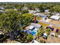 Aerial view of the house showcasing the backyard pool, spacious lot, and the home's location within a lush community at 8829 93Rd St, Seminole, FL 33777