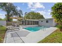 Inviting backyard with a sparkling pool, screened-in lanai, lounge chairs, and a shaded seating area for relaxation at 8829 93Rd St, Seminole, FL 33777