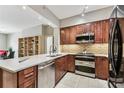 Modern kitchen with stainless steel appliances, granite countertops, and wood cabinets offers great prep and cooking space at 100 4Th S Ave # 220, St Petersburg, FL 33701