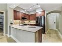 Updated kitchen boasts stainless steel appliances, tile backsplash, wooden cabinets and quartz breakfast bar at 100 4Th S Ave # 220, St Petersburg, FL 33701