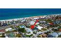 Expansive elevated aerial view showcasing nearby beach access, a beautiful neighborhood, and coastal charm at 103 Morgan Dr, Belleair Beach, FL 33786