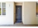 Welcoming front door with a cute doormat on a brick entry at 1030 Tidewater Shores Loop # 104, Bradenton, FL 34208