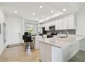 Open-concept kitchen with an island, stainless appliances, and ample countertop space at 1030 Tidewater Shores Loop # 104, Bradenton, FL 34208