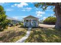 Quaint single-story home with a welcoming front porch and a partially shaded lawn at 1160 36Th N Ave, St Petersburg, FL 33704