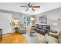 Bright living room with a large window, wood floors, neutral walls, and stylish furnishings at 118 Stafford Dr, Palm Harbor, FL 34684