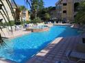Resort-style community pool with comfortable lounge chairs and lush landscaping at 1226 S Missouri Ave # 1013, Clearwater, FL 33756