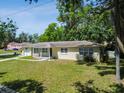 Charming one-story home with a welcoming front porch and lush greenery under a sunny sky at 1231 27Th S Ave, St Petersburg, FL 33705