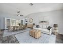 Bright living room boasts a modern interior, a long dining table, and natural light from the french doors at 13102 Wagner Dr, Hudson, FL 34667