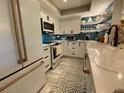 Modern kitchen features custom cabinets, countertops, and stainless steel appliances at 2055 Gulf Of Mexico Dr # G2-213, Longboat Key, FL 34228