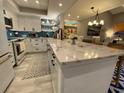 Open kitchen with a large island, custom cabinets, and designer finishes at 2055 Gulf Of Mexico Dr # G2-213, Longboat Key, FL 34228