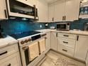 This modern kitchen features stainless steel appliances and custom cabinetry at 2055 Gulf Of Mexico Dr # G2-213, Longboat Key, FL 34228