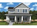 Charming two-story home with gray siding, white trim, stone accents and a welcoming front porch at 2301 Burlington Ave, St Petersburg, FL 33713
