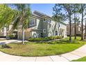 Landscaped townhome featuring a two-car garage and lush green lawn, offering curb appeal at 2759 Conch Hollow Dr, Brandon, FL 33511