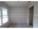 Unfinished room featuring fresh drywall, a modern window, and an open doorway ready for customization at 2801 Marrakesh Ln, Sarasota, FL 34234