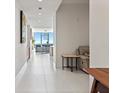Bright hallway with white tile floors leading to an open living area with beautiful views at 301 1St S St # 3207, St Petersburg, FL 33701