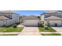 Well-maintained home featuring a two-car garage, landscaping, and long driveway at 30364 Marquette Ave, Wesley Chapel, FL 33545