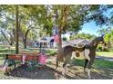 Nostalgic scene featuring patriotic decor, a wooden horse, and a view of the home's inviting exterior at 37410 Dixie Ave, Dade City, FL 33525