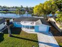 Aerial view of a charming single Gathering home with an attached garage and front porch at 3814 Sunray Dr, Holiday, FL 34691