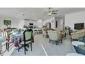 Open-concept living space featuring tile floors, neutral walls, and an adjoining kitchen and dining area at 6727 Bar S Bar Trail, Zephyrhills, FL 33541