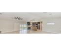 Open concept kitchen with stainless steel appliances, tile floors and sliding glass doors to the backyard at 921 Woodland Dr, Palm Harbor, FL 34683