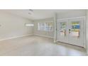 Bright living room with white walls, tile floor and a window that lets in plenty of natural light at 921 Woodland Dr, Palm Harbor, FL 34683