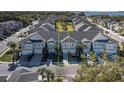 Exterior shot of a townhome showing the garage, yard, and neighboring houses at 1010 Mango Ct, Oldsmar, FL 34677